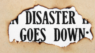 Disaster Goes Down text with burnt paper around it