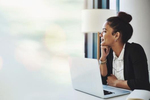Engineering Firms Remain Resilient Amid Growing Economic Uncertainty, New ACEC Research Institute Study Finds Business woman happy in front of laptop