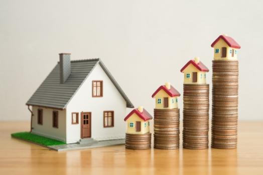 Brightshore Capital Launches $250 Million Property Platform Coins stacked up next to house